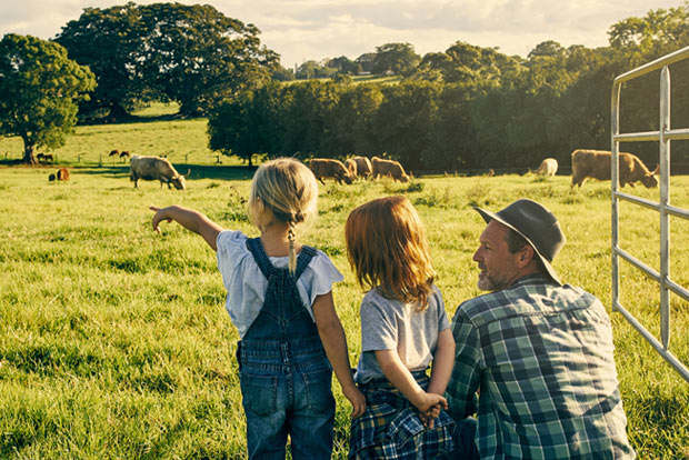Young kids with a parent looking at nature.